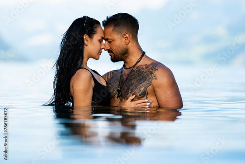 Summer sexy couples. Romantic couple in sea water. Beautiful young couple in love on the lake. Sexy couple kissing by the sea. Dream vacation. Sex on the beach. Erotic couple kissing in the water.