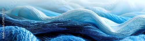 Vibrant shades of blue flow in a wavelike pattern across this textured knit fabric, illustrating softness and depth.