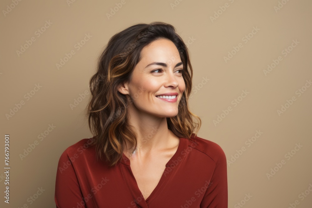 Portrait of happy smiling woman in red dress, over beige background Portrait of happy smiling woman in red dress, over beige background
