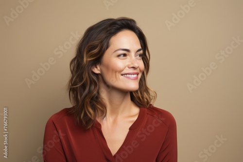 Portrait of happy smiling woman in red dress, over beige background