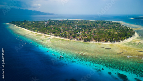 Aerial view of fringing coral reef surrounding a small tropical island in a warm ocean (Gili Air, Indonesia)
