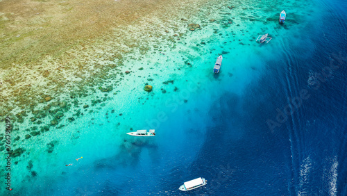 Aerial view of swimmers and snorkellers from tourist boats above a tropical coral reef in a warm ocean (Gili Air, Indonesia) © whitcomberd