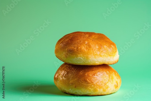 Two Rolls Stacked on Green Background