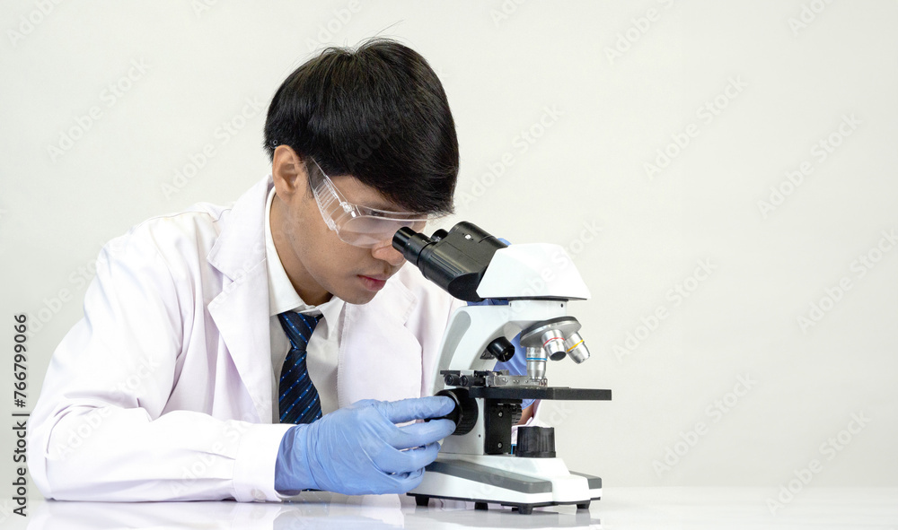 Portrait asian man student scientist doctor in shirt gown one person wokk job plant looking hand holding control microscope on white table see the results of scientific experiments inside laboratory Portrait asian man student scientist doctor in shirt gown one person wokk job plant looking hand holding control microscope on white table see the results of scientific experiments inside laboratory