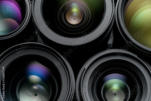Lenses for professional photo camera with colorful reflections. © Kuzmick