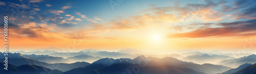 The sun setting behind a silhouette of mountains © MastersedZ