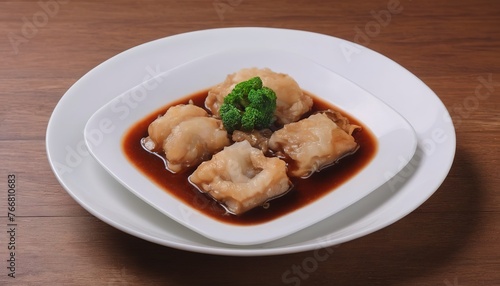 Braised Fish Maw in Red Gravy on wood background