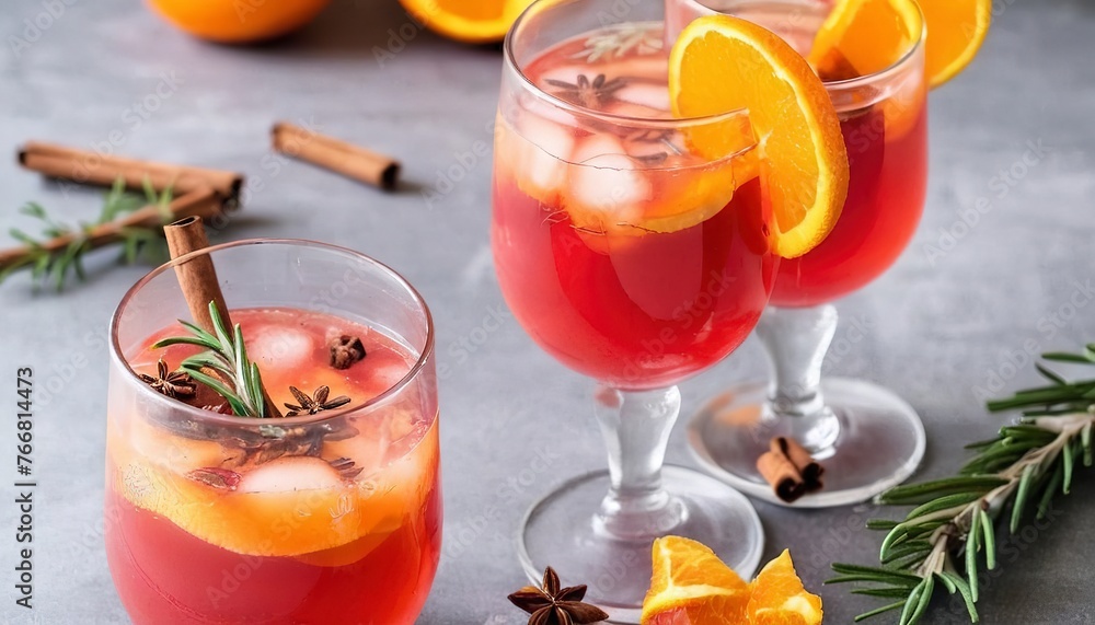 Cranberry orange punch with cinnamon and rosemary in a glass