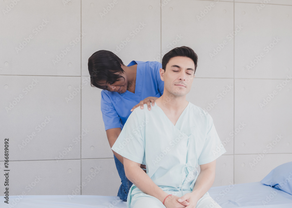 Portrait patient caucasian man with woman nurse black people carer physical therapist two person sitting talk helping support give advice and holding relax massage on back body inside hospital clinic Portrait patient caucasian man with woman nurse black people carer physical therapist two person sitting talk helping support give advice and holding relax massage on back body inside hospital clinic