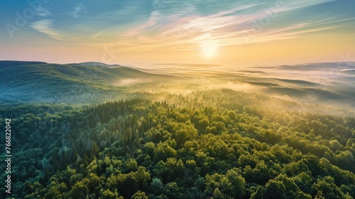 The top view picture of the wild nature that fills with green forrest, great mountain, cloudscape, blue sky, and the sun in the bright morning day in the summer or spring time of the years. AIGX01.