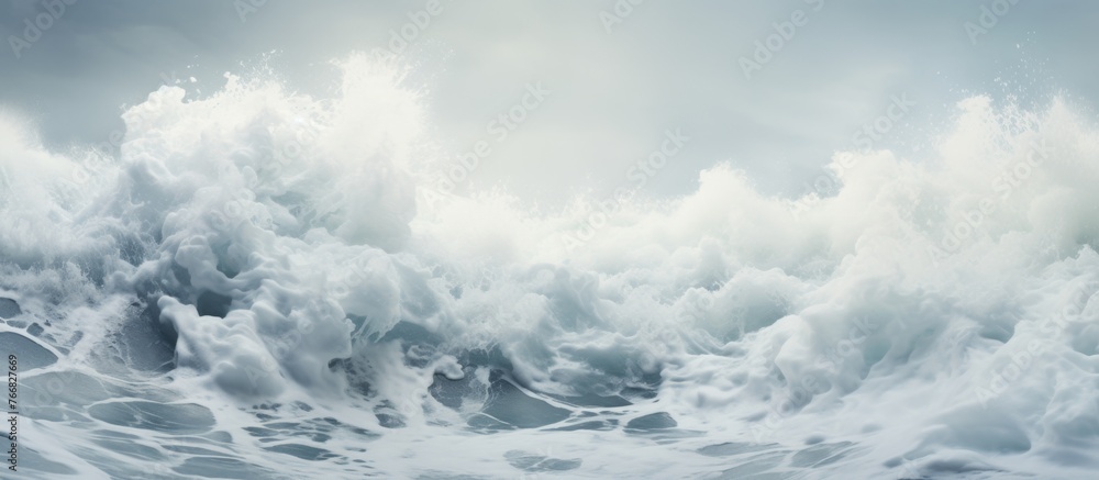 A colossal wave, formed by the interaction of wind and fluid water, crashes dramatically onto the shore under the vast sky, creating a powerful natural landscape - obrazy, fototapety, plakaty 
