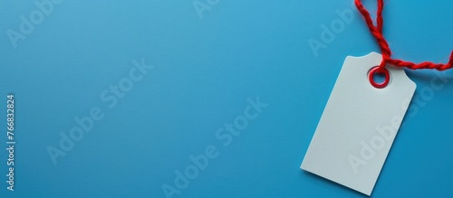 Badge template displayed on a blue background, featuring an empty name tag with a red string. photo