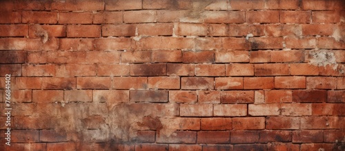 Detailed view of an aged brick wall with a distressed and gritty appearance  showing various textures and colors