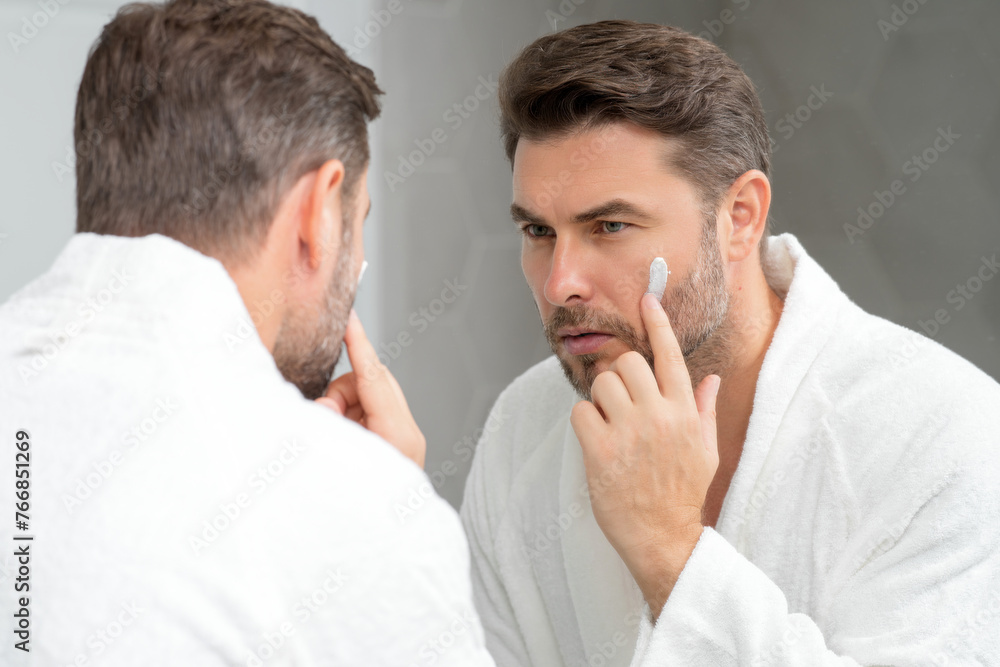 Fototapeta premium Beautiful man with clean perfect skin. Beauty male skin care. Cosmetology beauty spa. Male coscmetic. Face care skincare and beauty concepts. Handsome man with soft skin. Male healthy skin and spa.