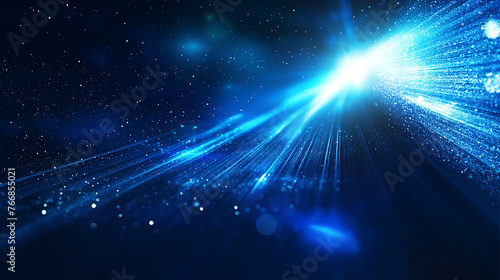 Glowing light abstract background with ray  light beams and scattered particles on dark blue background.