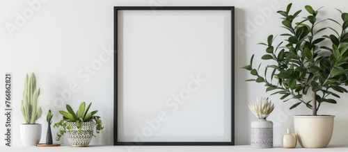 The image shows a black square frame with home decor and potted plants on a white shelf against a wall, with space for text.
