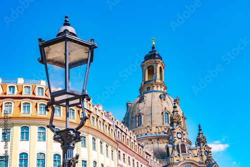 Dresden, Germany. Church of our Lady at Neumarkt square in downtown of Dresden at sunny summer day with blue gradient sky and old street light