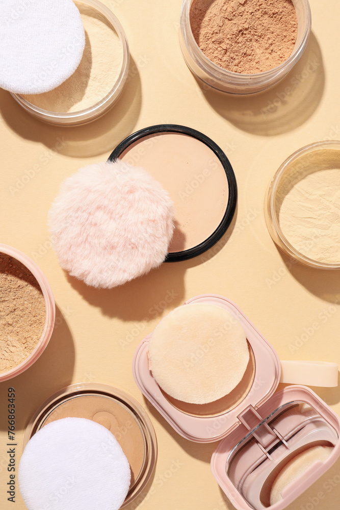 Bottles of face powder, different shades, on a pastel background. Bottles of face powder, different shades, on a pastel background.
