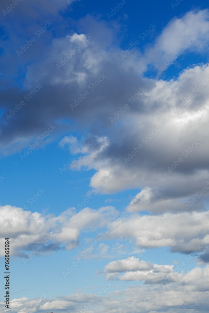 Blue sky background with clouds.Copy space. Vertical photo. Background. Blue sky background with clouds.Copy space. Vertical photo. Background.