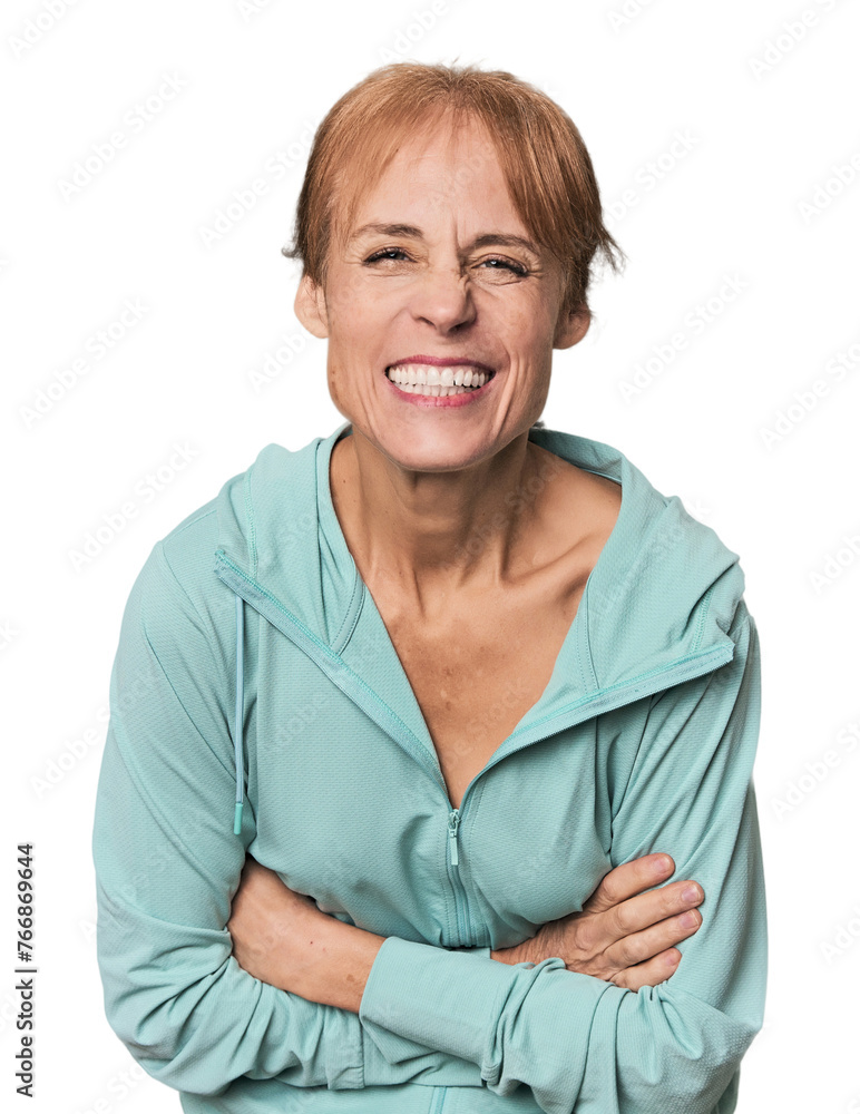Young mid-aged woman in sportswear in studio laughing and having fun. Young mid-aged woman in sportswear in studio laughing and having fun.