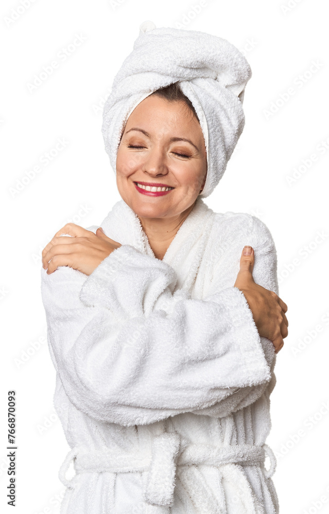Caucasian woman in bathrobe and towel hugs, smiling carefree and happy. Caucasian woman in bathrobe and towel hugs, smiling carefree and happy.