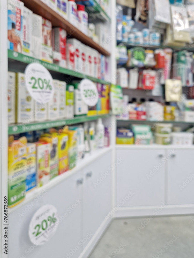 Defocus background with stocked shelves on sale inside the drugstore. 20% discount on cosmetics and healthcare products