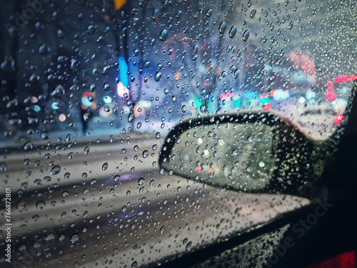 Canvastavla Melted snow and sleet drops on the car window with view to the side mirror