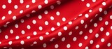 A close up of a textile featuring a vibrant orange cloth with magenta polka dots arranged in circles, creating an entertaining pattern of tints and shades