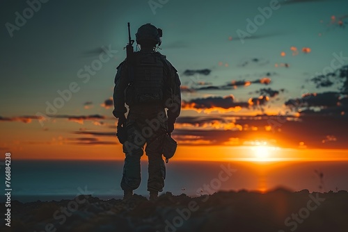 Soldier Standing on Top of Hill at Sunset