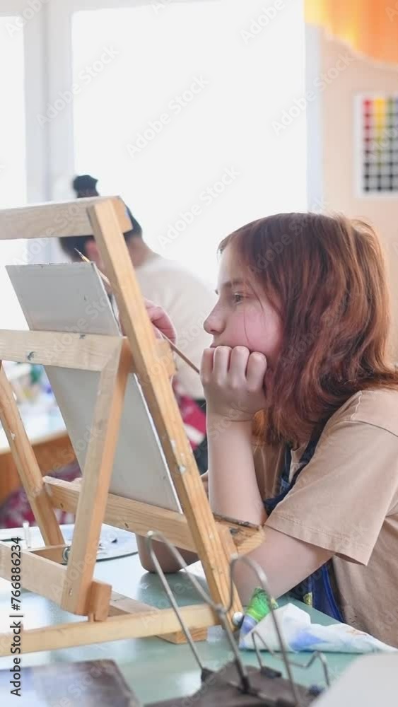 Cute girl in art studio painting oil painting. Hobbies, Relaxation, Art Therapy Cute girl in art studio painting oil painting. Hobbies, Relaxation, Art Therapy
