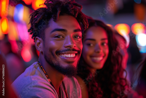 Portrait of happy young couple sitting together at a night club