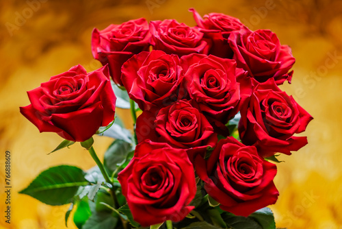  Bouquet of red roses on a yellow background.