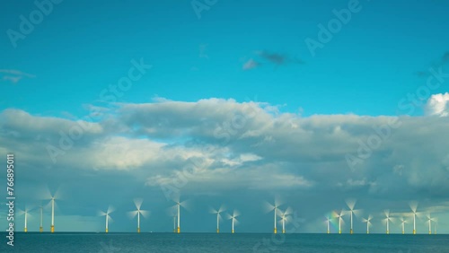 A timelapse of an offshore windfarm with a rainbow photo