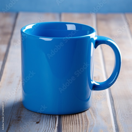 A vibrant blue coffee mug, handle positioned to the side. Smooth ceramic surface catches the light photo