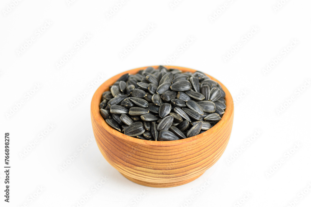 black sunflower seeds in a small wooden cup black sunflower seeds in a small wooden cup