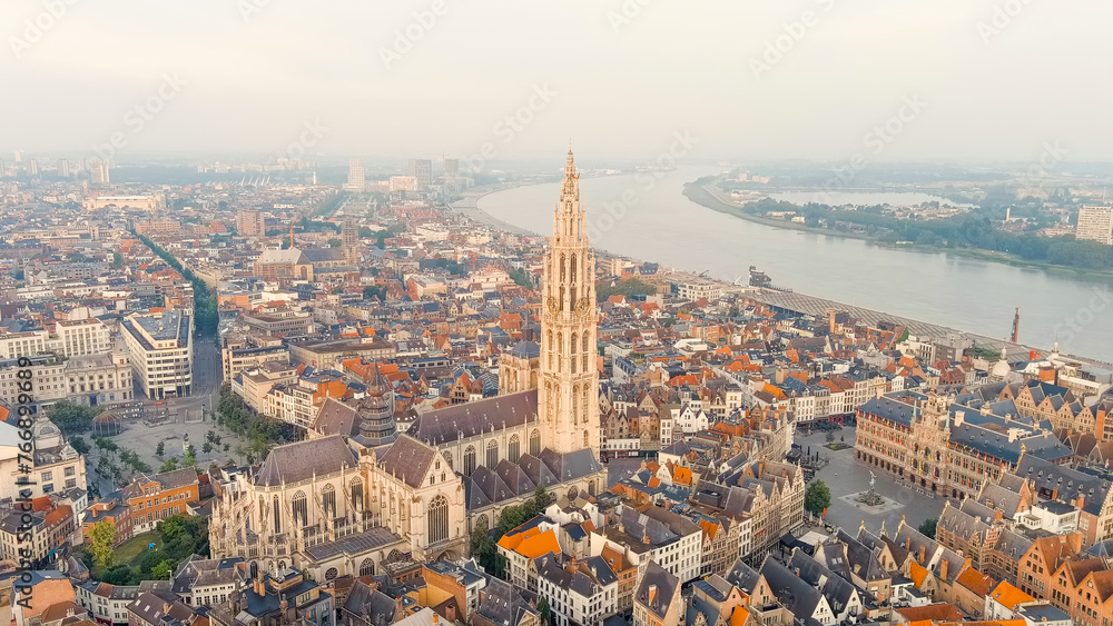 Antwerp, Belgium. Spire with the clock of the Cathedral of Our Lady (Antwerp). Historical center of Antwerp. City is located on river Scheldt (Escaut). Summer morning, Aerial View - obrazy, fototapety, plakaty 