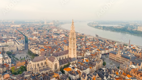 Antwerp, Belgium. Spire with the clock of the Cathedral of Our Lady (Antwerp). Historical center of Antwerp. City is located on river Scheldt (Escaut). Summer morning, Aerial View