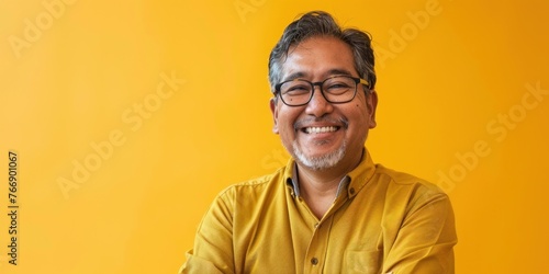South Asian Man Smiling on Yellow photo