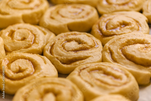 tray of cinnamon rolls ready to go into the oven, macro comfort food background © Tamara Kulikova