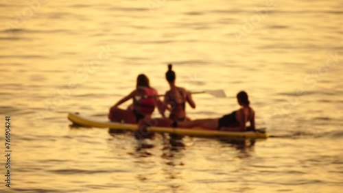 Wallpaper Mural Defocused sea ocean beach of hotel or resort with Lounge bed on hot summer day. Abstract bokeh background of blurred resting and swimming people on beach at blue sea. Holiday, vacation and recreation. Torontodigital.ca