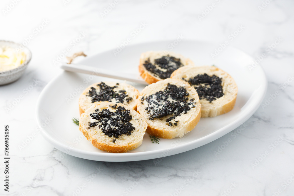 Black caviar on fresh baguette bread