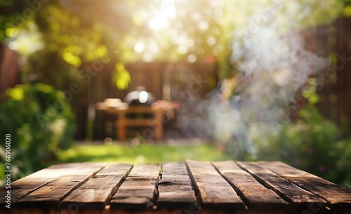 Blurred background of an empty wooden table with barbecue grill in the garden copy space for product placement or text