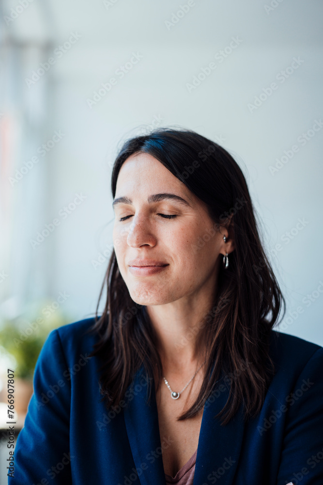 Smiling businesswoman with eyes closed at home Smiling businesswoman with eyes closed at home