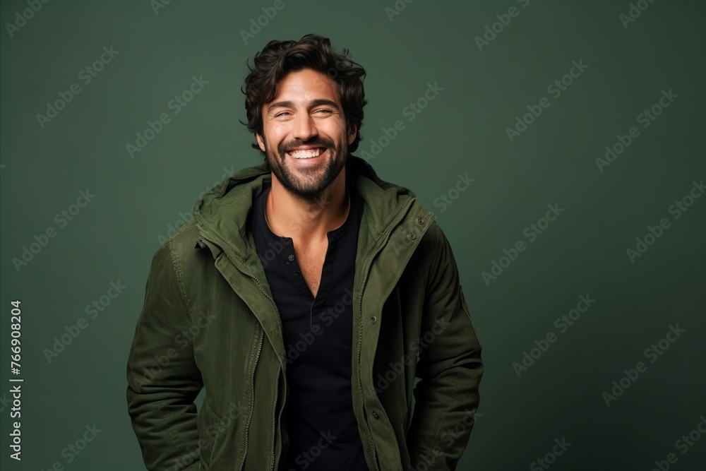 Portrait of a handsome man smiling at camera isolated over green background Portrait of a handsome man smiling at camera isolated over green background