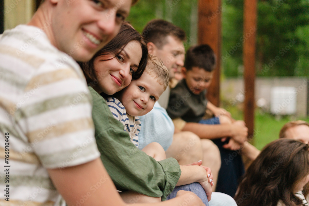 Happy family gathering with friends on summer vacation Happy family gathering with friends on summer vacation