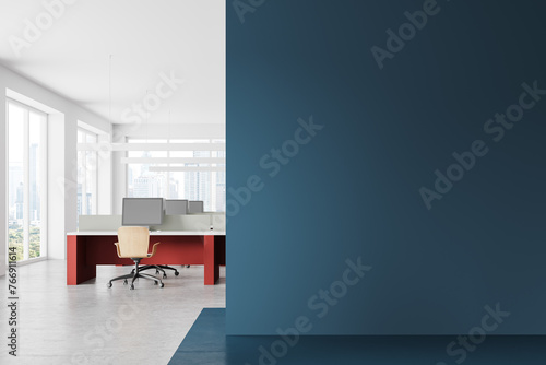 Bright blue and white open space office with blank wall