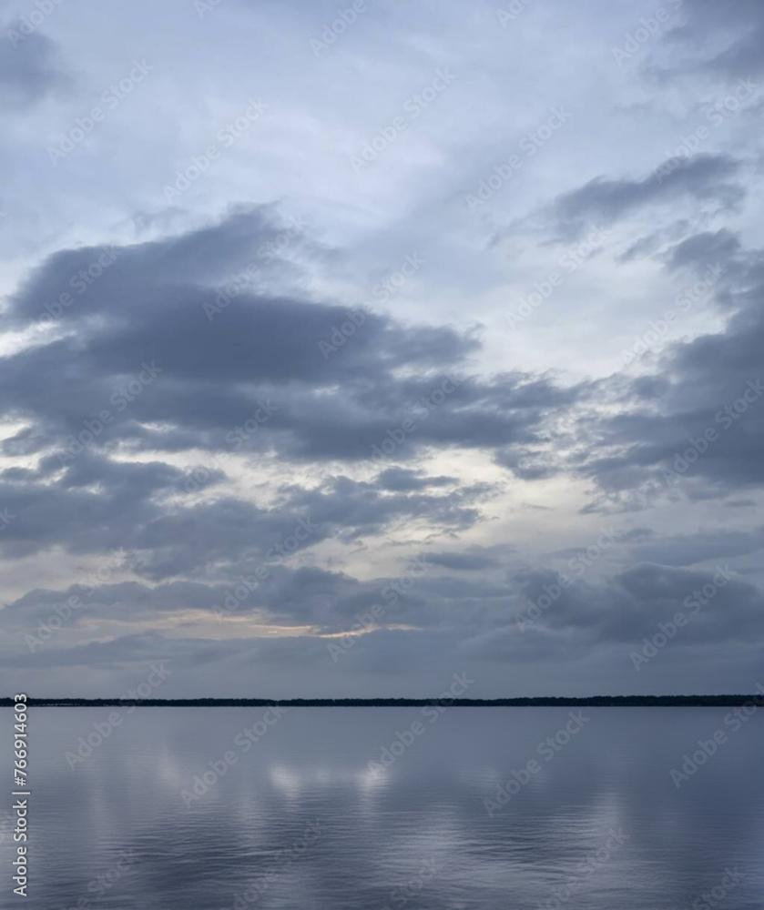 Stormy sky over a lake with clouds Stormy sky over a lake with clouds