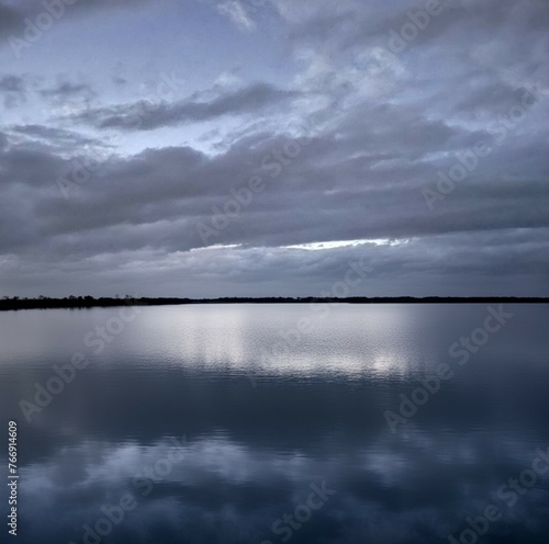 Dark sky over Lake Conroe in the evening © Wirestock