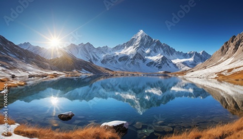 The first rays of sunlight spread over a frosty mountain landscape, reflecting in the lake below. The sun's debut enhances the striking contrast between the snowy peaks and the blue sky. AI generation