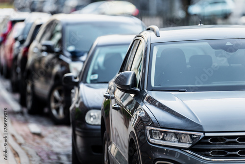 Parked cars next to a street close up on car mirrors